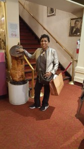 Rubbing a replica of the good luck stump at The Apollo Theater.